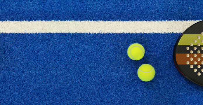 Close up of a padel ball and racket on a blue syntehtic playground