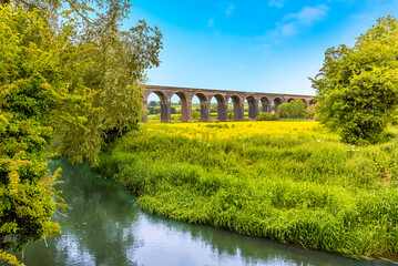 A view across a tributary to the Welland river of the Harringworth railway viaduct, the longest...