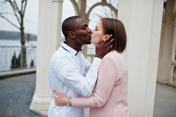 Happy multiethnic couple in love story. Relationships of african man and white european woman.