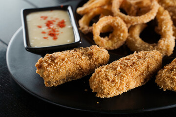 Beer snacks. Breaded meat appetizer and onion rings.
