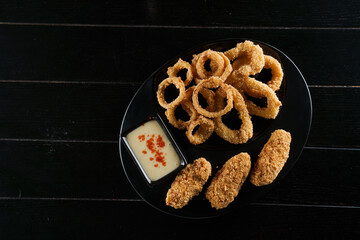 Beer snacks. Breaded meat appetizer and onion rings.