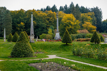 English-style park with terraces in autumn day, rose garden, statues near romantic medieval gothic and baroque castle Konopiste, Benesov, Chateau at Central Bohemia, Czech Republic