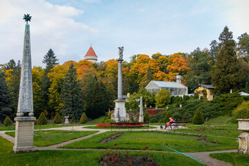 Fototapeta na wymiar English-style park with terraces in autumn day, rose garden, statues near romantic medieval gothic and baroque castle Konopiste, Benesov, Chateau at Central Bohemia, Czech Republic