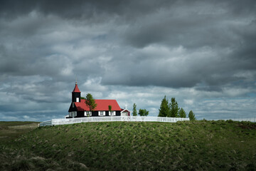 Old wooden church with red roof in Iceland