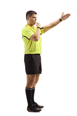 Football referee using a whistle and pointing with his hand