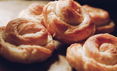 Chelsea buns. Freshly baked rolls buns on a brown background