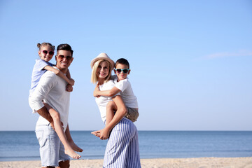 Happy family at beach on sunny day