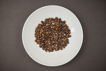 Roasted coffee beans in a white plate