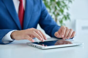 Accountant checks business report on digital tablet.