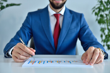 Manager working in office and analyzing financial results.