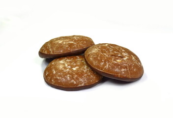 Glazed gingerbread lebkuchens with chocolate isolated on white. German round gingerbread called 'Lebkuchen' 