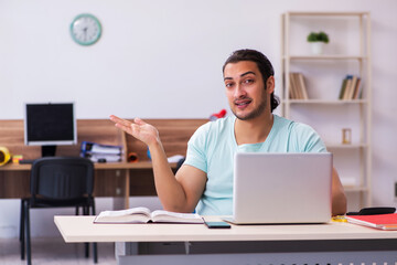 Young male student preparing for exams at home in tele-education