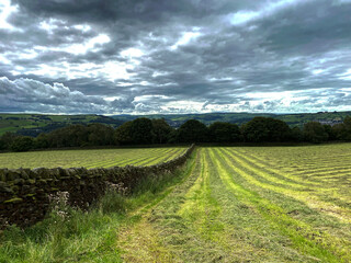Fototapeta na wymiar Storm clouds, gathering over a freshly cut wheat field, on the hills near, Bingley, Bradford, UK
