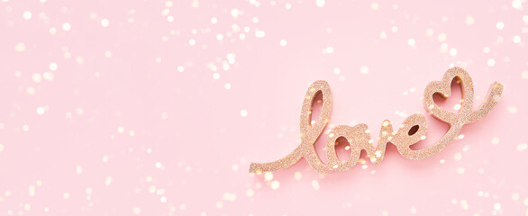 Valentines Day concept banner. Golden word LOVE on pink background. Top view, copy space