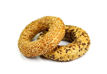 Fullgrain bagel with seeds isolated on white background. Fresh breakfast bread bagel roll with seeds isolated on white background.