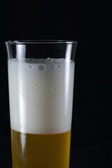 Glass of Light wheat Beer isolated on black background