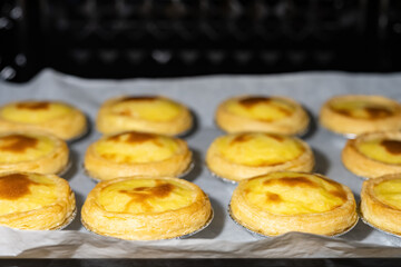 fresh made egg tarts in an oven