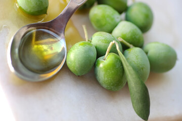 olives fruit on table and spoon of olive oil