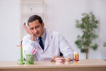 Young male doctor stomatologist working in the clinic