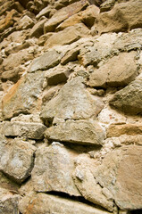 Aged stone wall texture. Textured grunge wall surface background pattern of masonry of old medieval castle