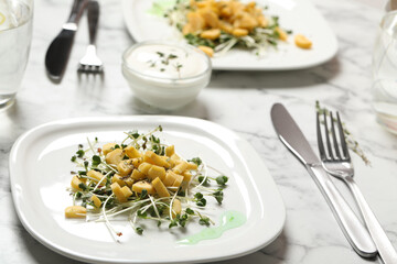 Delicious fresh carrot salad on white marble table, closeup