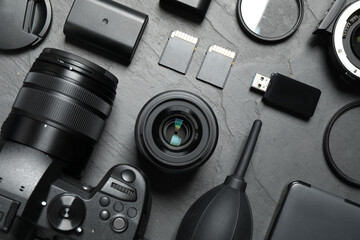 Flat lay composition with camera and video production equipment on grey stone background