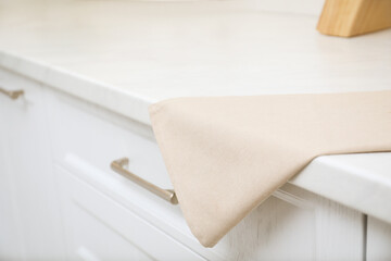 Fototapeta na wymiar Clean kitchen towel on counter at home, closeup