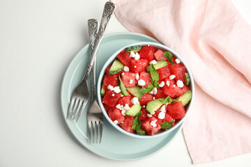 Delicious salad with watermelon, cucumber and cheese on white table, flat lay