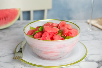 Delicious salad with watermelon on white marble table