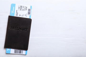 Passport with ticket on white wooden table, top view and space for text. Travel agency concept