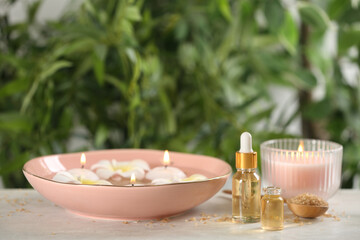 Beautiful spa composition with aroma oil and candles on table