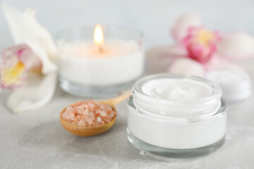 Fototapeta na wymiar Beautiful spa composition with cream and sea salt on marble table, closeup