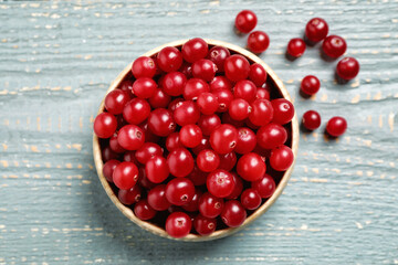 Tasty ripe cranberries on grey wooden table, flat lay