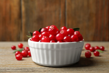 Tasty ripe cranberries on wooden table, closeup