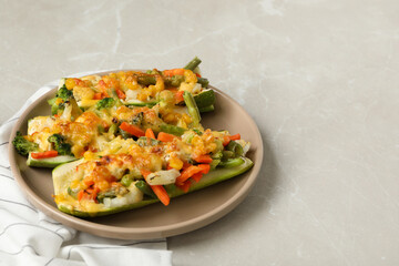 Baked stuffed zucchinis served on light grey table