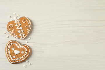 Tasty heart shaped gingerbread cookies on white wooden table, flat lay. Space for text