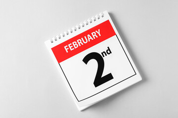 Top view of calendar with date February 2nd on light background. Groundhog day