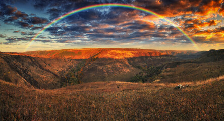 Rainbow with clouds over the canyon. autumn landscape