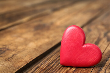 Fototapeta premium Decorative heart on wooden table, space for text. Valentine's Day