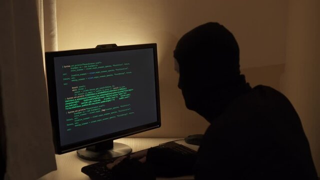 Hacker looking for a flaw in the program code.