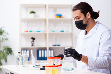 Young male chemist working in the lab