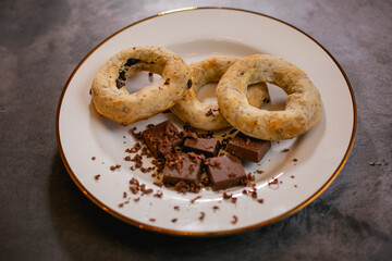 A white plate with gluten-free chocolate donuts and candy bars