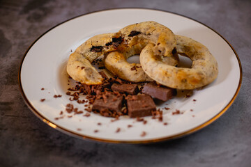A white plate with gluten-free chocolate donuts and candy bars