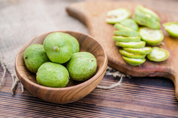 Ingredients for tincture of green walnuts in a wooden ecological plate without chemicals. zero waste