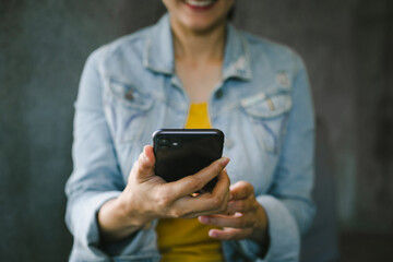 woman work using cell phone hand holding mobile texting message contact us.chatting,search internet information in office.technology device communication connecting