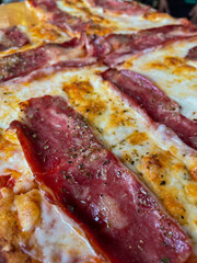 delicious slice of artisan bacon pizza. close up