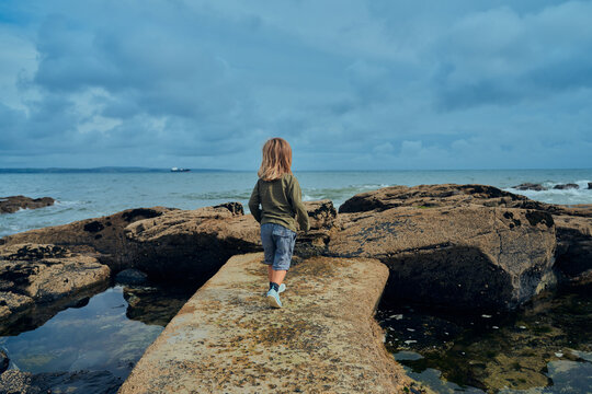 Preschooler on jetty byu the sea