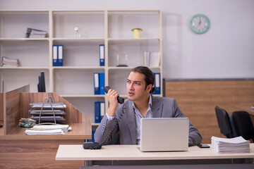 Young male employee working in the office