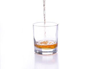 Whiskey poured into a glass