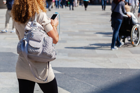 Woman With Handbag And Phone On The Move In The City